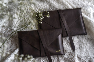 Leather print envelopes hold prints in two sizes. Journal-style wrap-around closure.